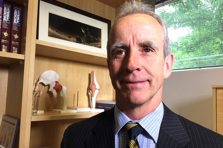 Headshot of Australian Olympic medical director Dr David Hughes looking at the camera.