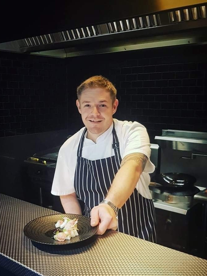 Aaron Tucker shows off his creation in a beautiful kitchen.