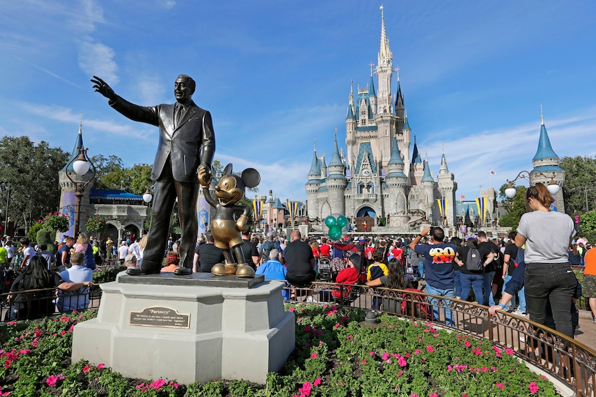 A statue of Walt Disney and Mickey Mouse stands in front of the Cinderella Castle at the Magic Kingdom in Walt Disney World, Florida, on January 9, 2019.