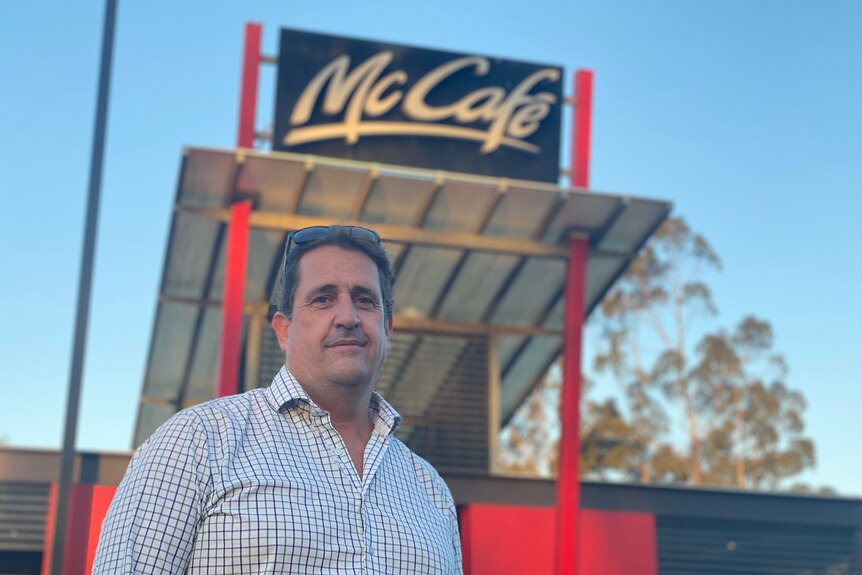 A man stands outside a McDonald's