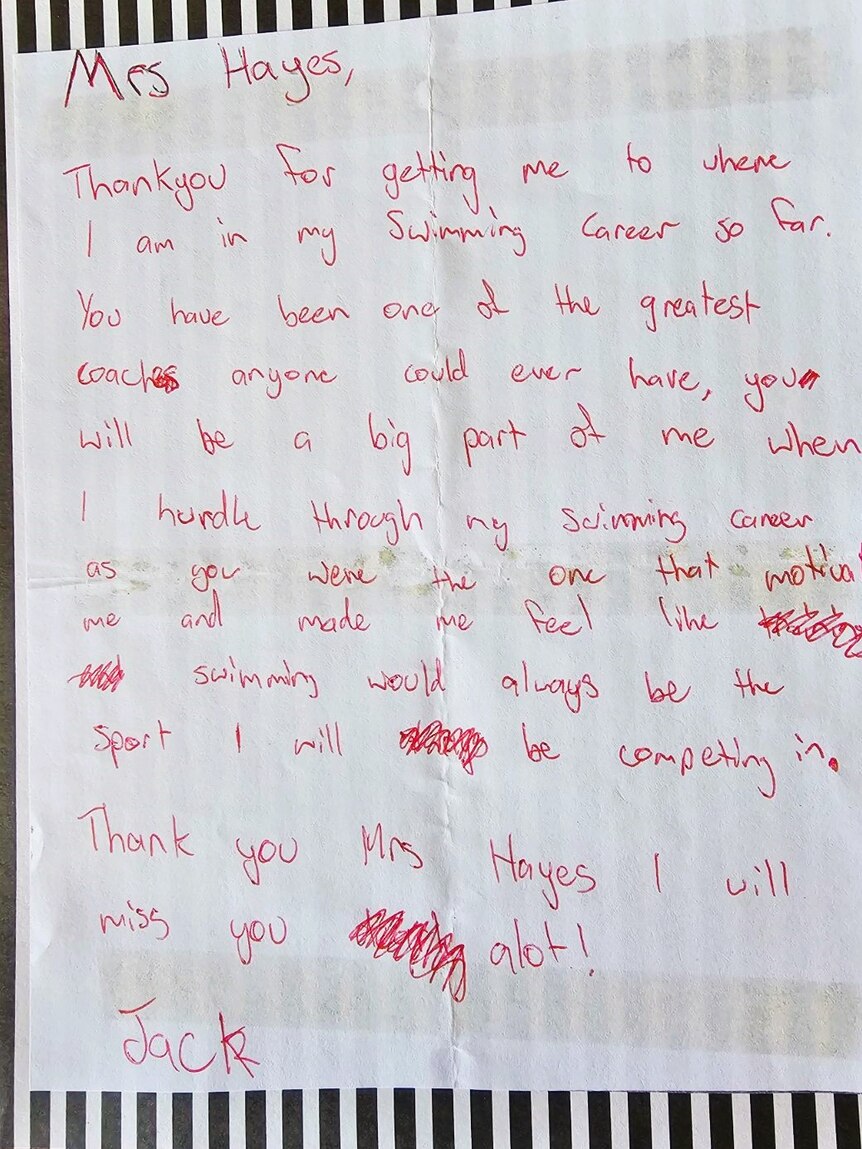 A letter on a piece of paper in red writing.
