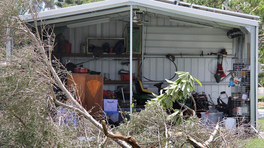 One end of a shed with a gaping hole in it after Cyclone Marcia ripped two roller doors off