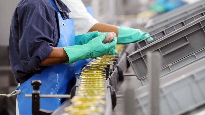 People work on a food production line in a French factory