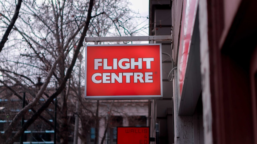 A red Flight Centre sign in the streets.