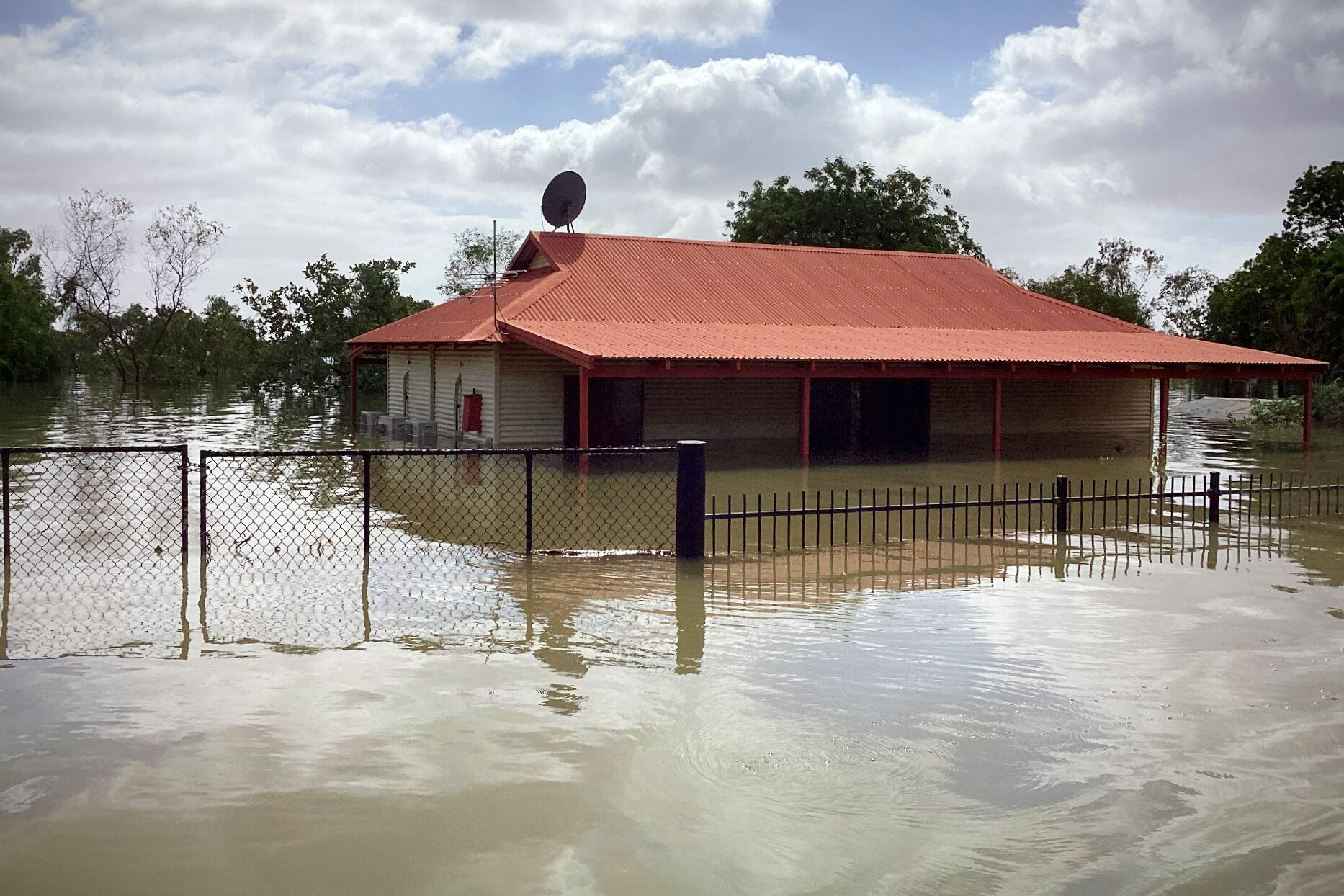 A house with a red roof underwater