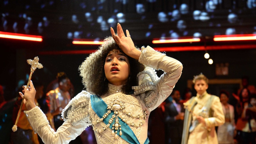 A scene from the tv show Pose with a woman dressed in royal outfit