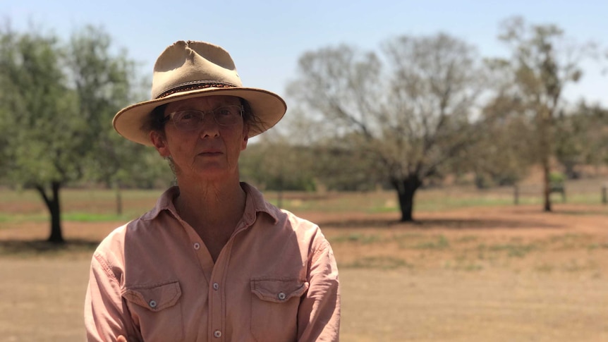 Margaret looking at the camera with trees and other land in the background