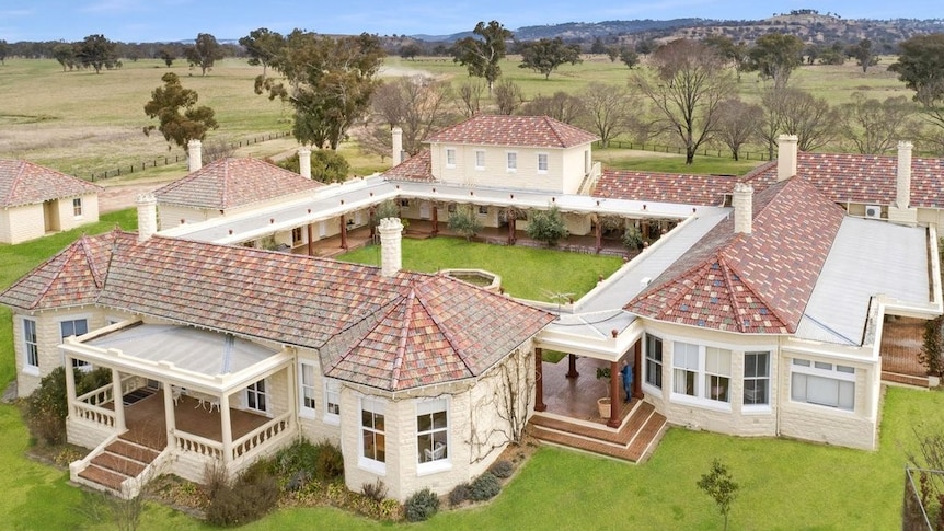 Aerial shot of a modern stone home built around a courtyard