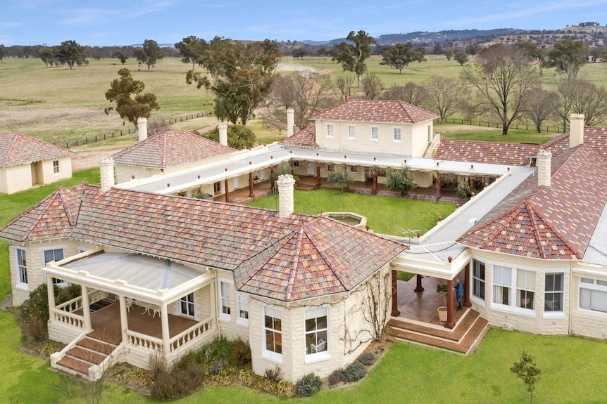 Aerial shot of a modern stone home built around a courtyard