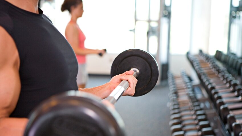 Man at a gym lifting weights.