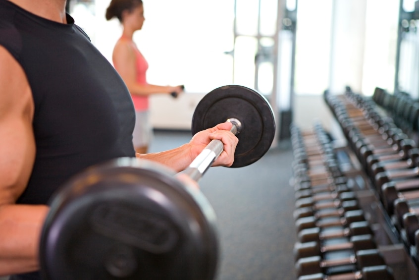 Man at a gym lifting weights.