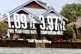 A poster at an NAB branch advertises a 1.89pc two-year fixed rate with a house in the image.