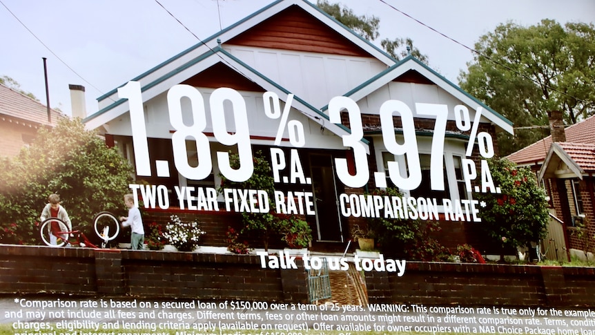 A poster at an NAB branch advertises a 1.89pc two-year fixed rate with a house in the image.