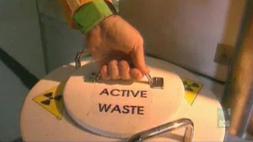 Good generic TV still of hand on handle of nuclear waste cannister (ABC)