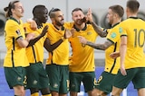 Socceroos celebrate by hugging each other