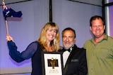 Peta Fielding, left, and Brennan Fielding, far right, receive their award in San Diego.