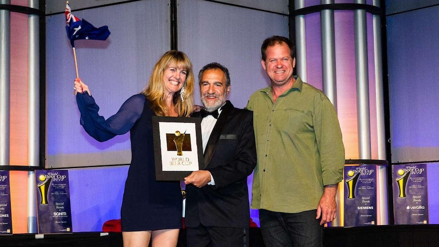 Peta Fielding, left, and Brennan Fielding, far right, receive their award in San Diego.
