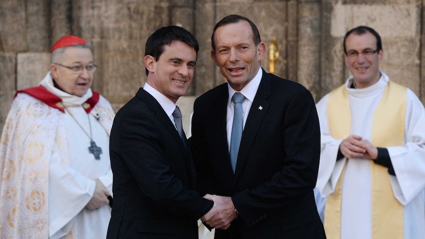 Australian Prime Minister Tony Abbott shakes hands with French Prime Minister Manuel Valls
