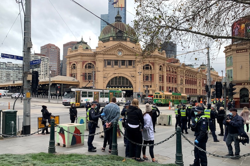 Crowds gather outside Melbourne's Flinders Street Station for a lockdown protest on July 24, 2021.