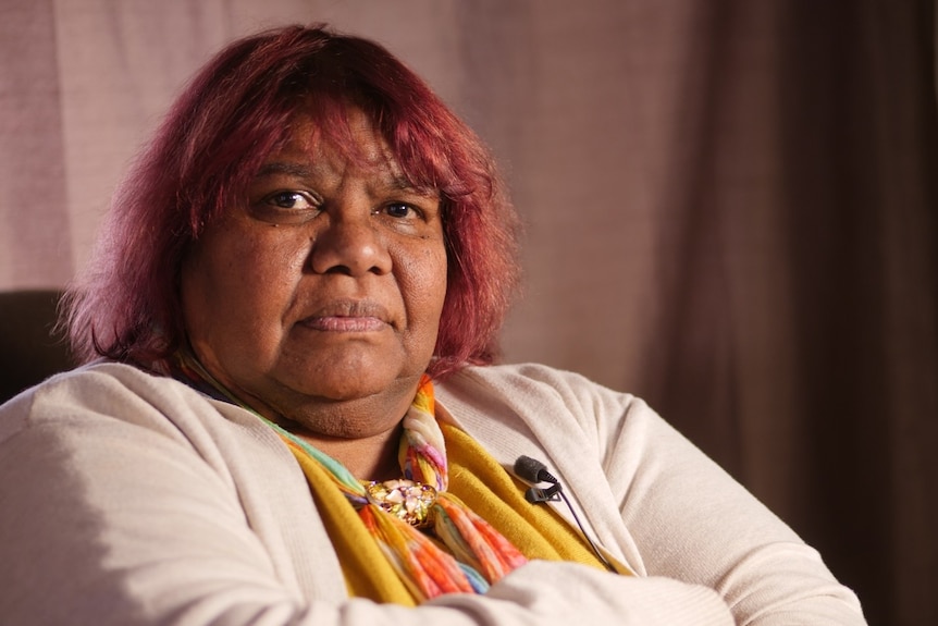 Indigenous woman Colleen Berry sitting with arms crossed