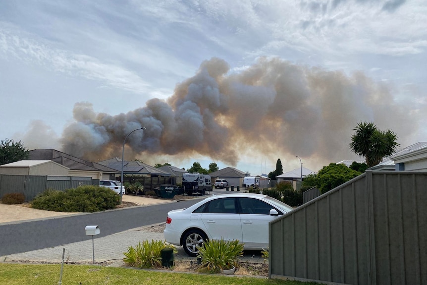 Smoke coming from behind a number of houses
