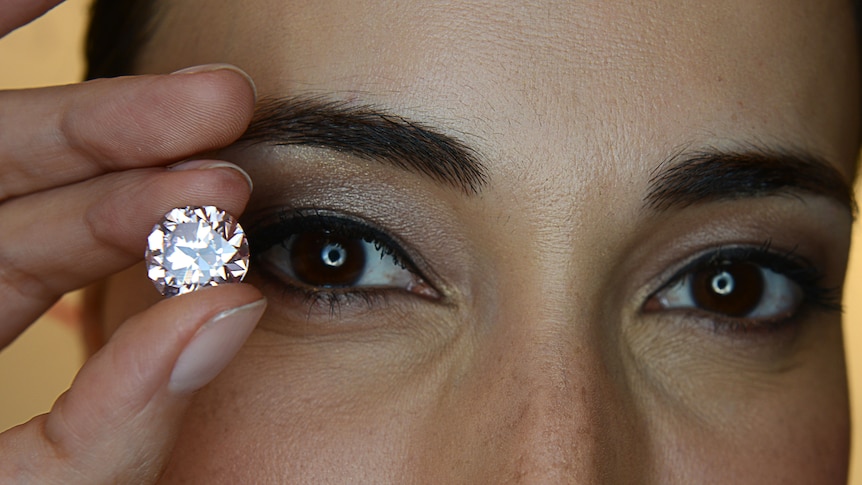 Model Lisa S holds a Martian Pink Diamond