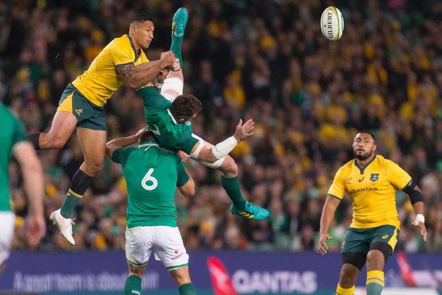 Israel Folau makes contact with Peter O'Mahony as they contest the ball in the third Test between Australia and Ireland.