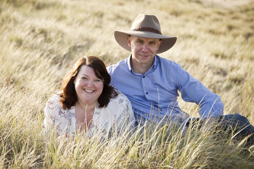 A smiling couple in a field