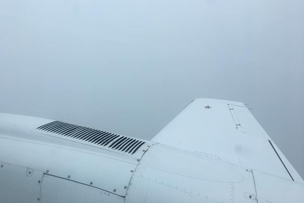 A plane wing surrounded by cloud