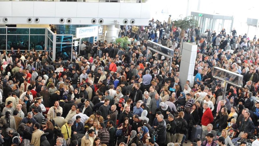 Checking in: Thousands gather in Cairo's international airport.
