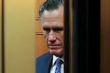 Mitt Romney's face seek through closing elevator doors.