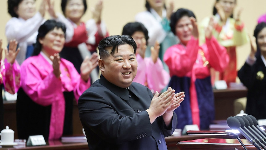 North Korea's leader Kim Jong Un applauds at the 5th National Meeting of Mothers in Pyongyang.