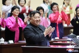 North Korea's leader Kim Jong Un applauds at the 5th National Meeting of Mothers in Pyongyang.