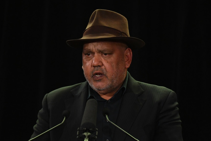Noel Pearson stands at a microphone.