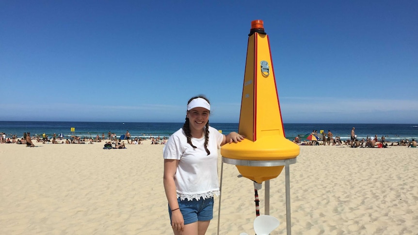 picture of maddison king at the beach with her Clever GIRL buoy.