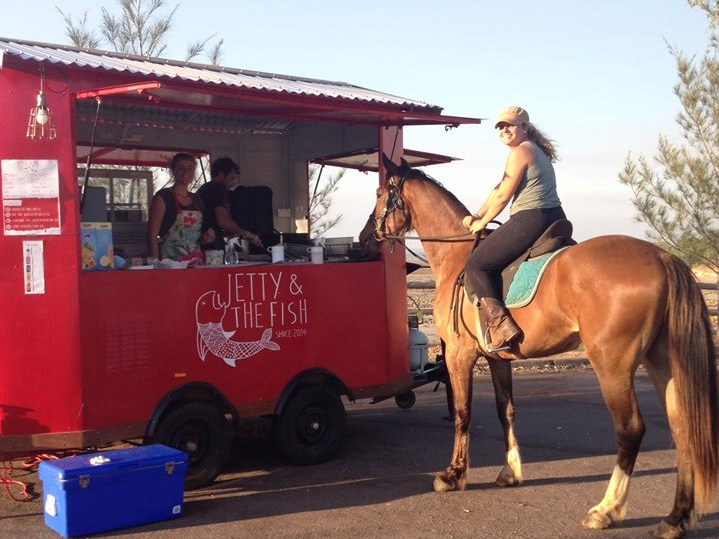 An equine diner and rider visits the Jetty and the Fish food van on the Darwin foreshore.