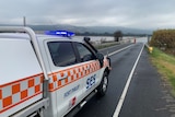 An SES ute sits on a flooded road in Yarra Glen