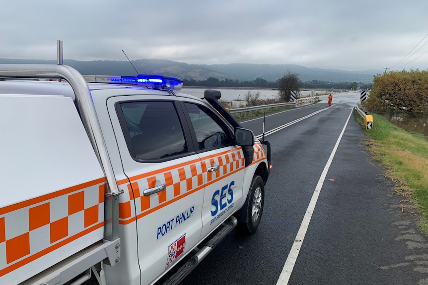 An SES ute sits on a flooded road in Yarra Glen