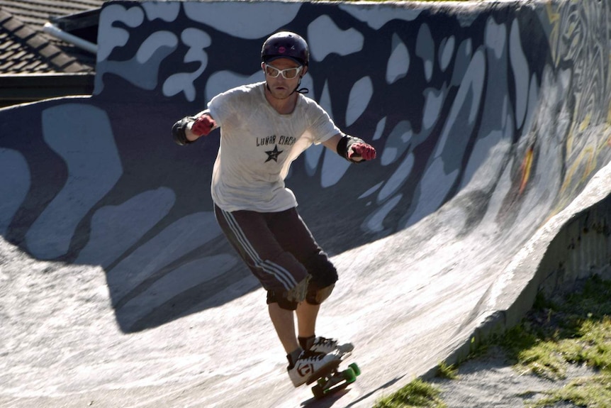 A skateboarder rehearses for 40th anniversary commemorations of the Snake Run.