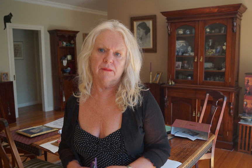 Carolyn Loughton stands in front of a dining table