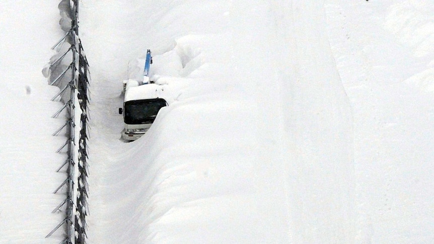 Snow covers vehicles on Hokkaido.