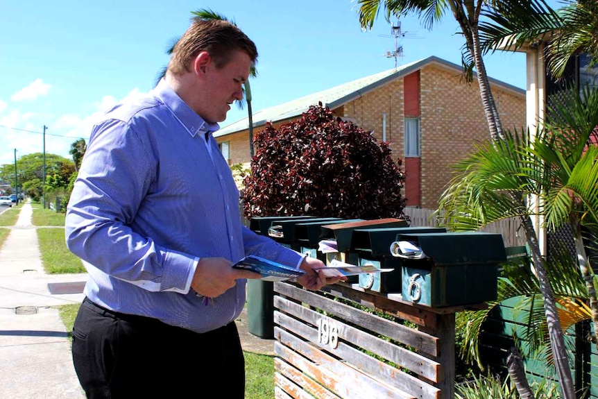 Chay Conaglen puts how-to-vote cards in letterboxes