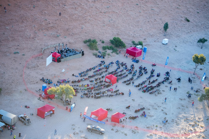 A birds-eye view of a small music festival in the desert.