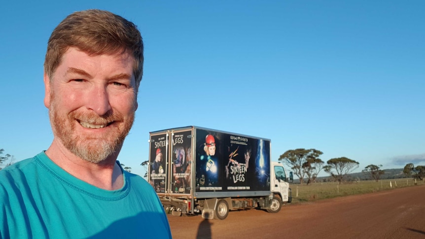 Niall Doran standing in the outback with the truck promoting his movie "16 Legs"
