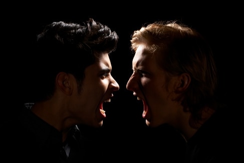 Teen boy and adult male yelling (Getty Images: Thomas Northcut)