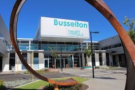 A multi-level hospital building with Busselton hospital written on it.