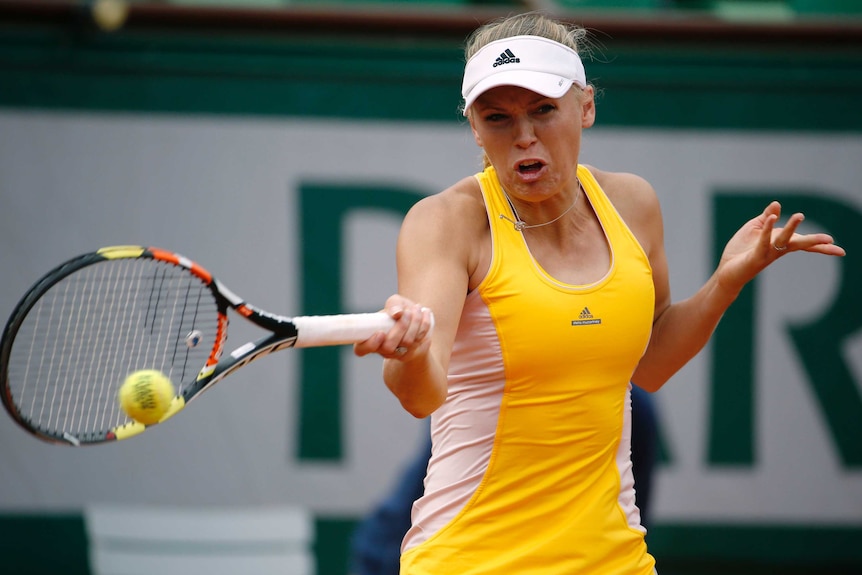 Caroline Wozniacki plays a forehand in her second-round loss to Julia Goerges