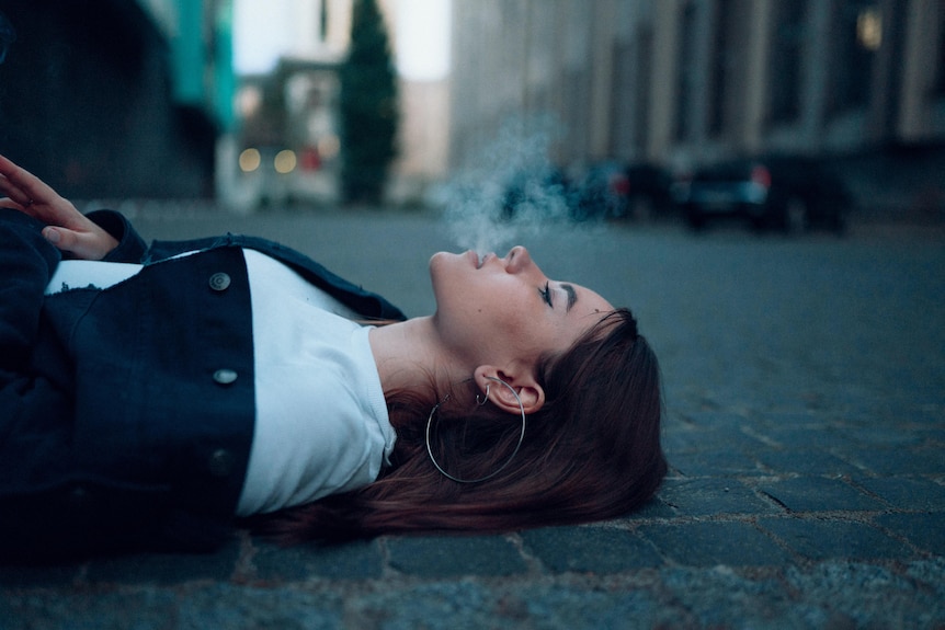 Woman lying down and smoking