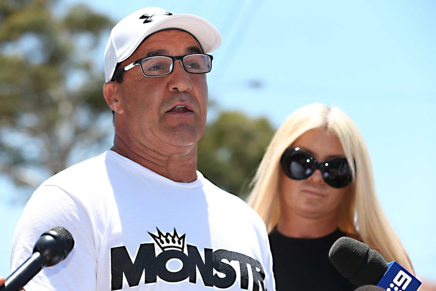 Jeff Fenech stands next to his wife Suzee while addressing the media