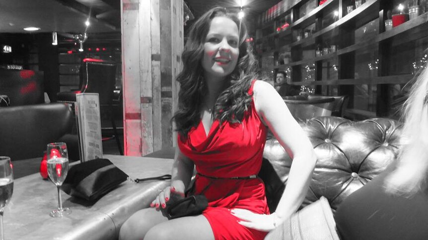 A Facebook photo of Kelly Brewster wearing a red dress.